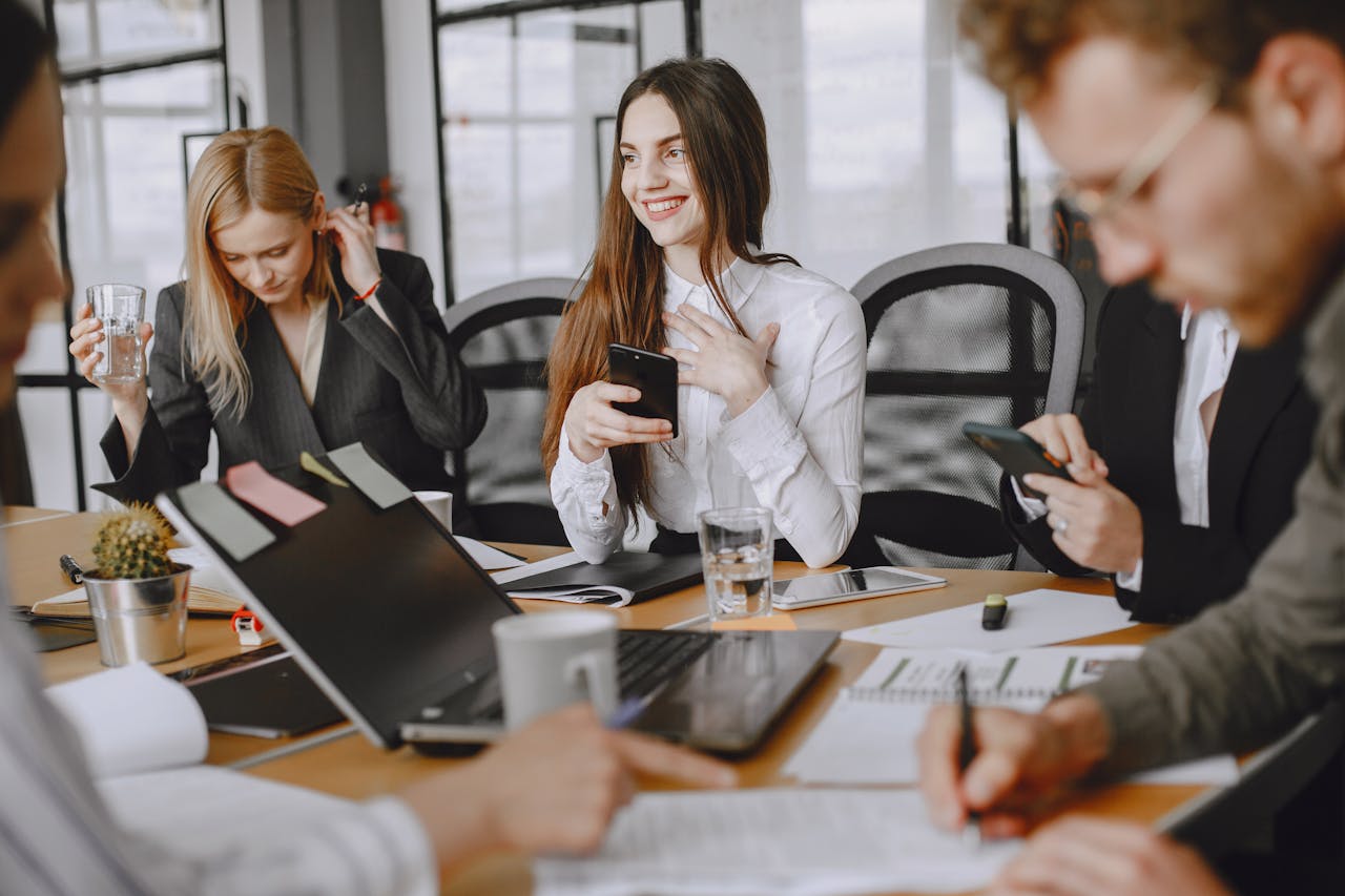 Business professionals engaging in a dynamic team meeting with modern technology.