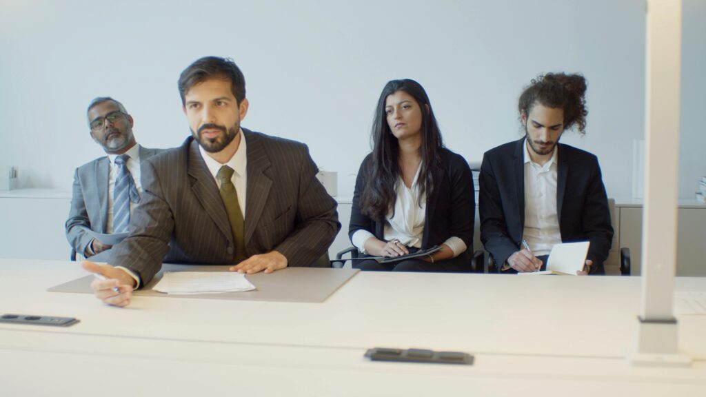 A diverse group of business professionals in a modern office setting, focusing on teamwork.